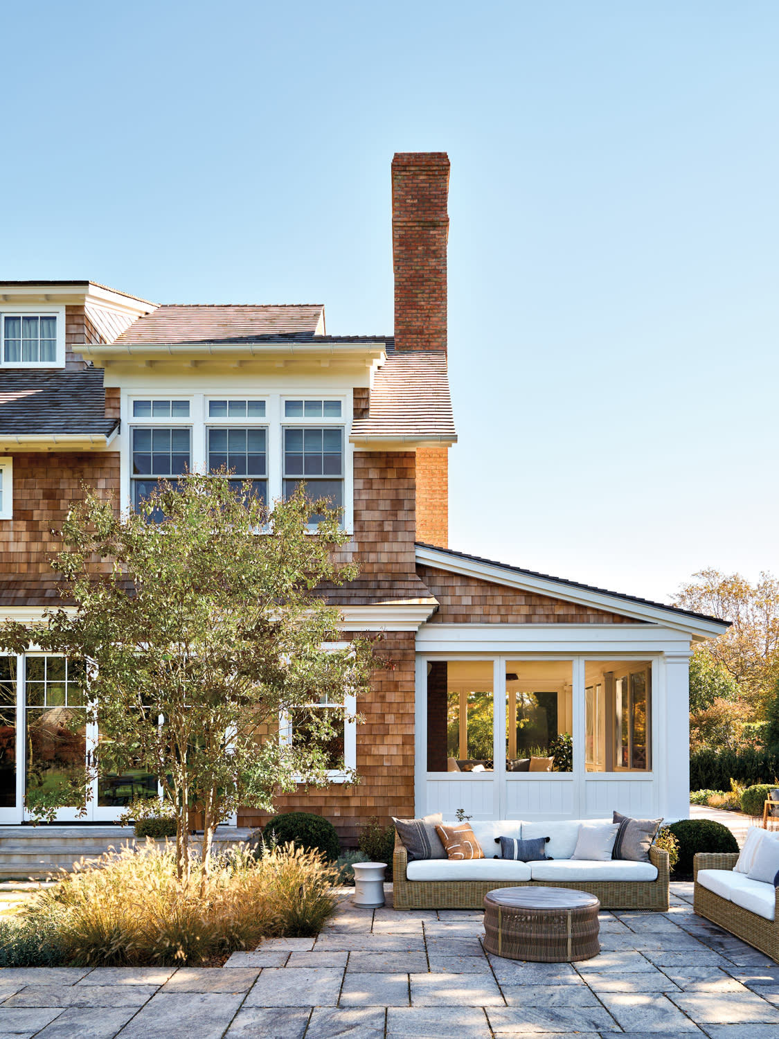 hardscaped patio of a Hamptons cottage-like abode