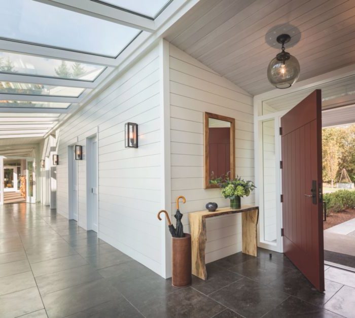 wood barn door on hinges used in white shiplap entryway