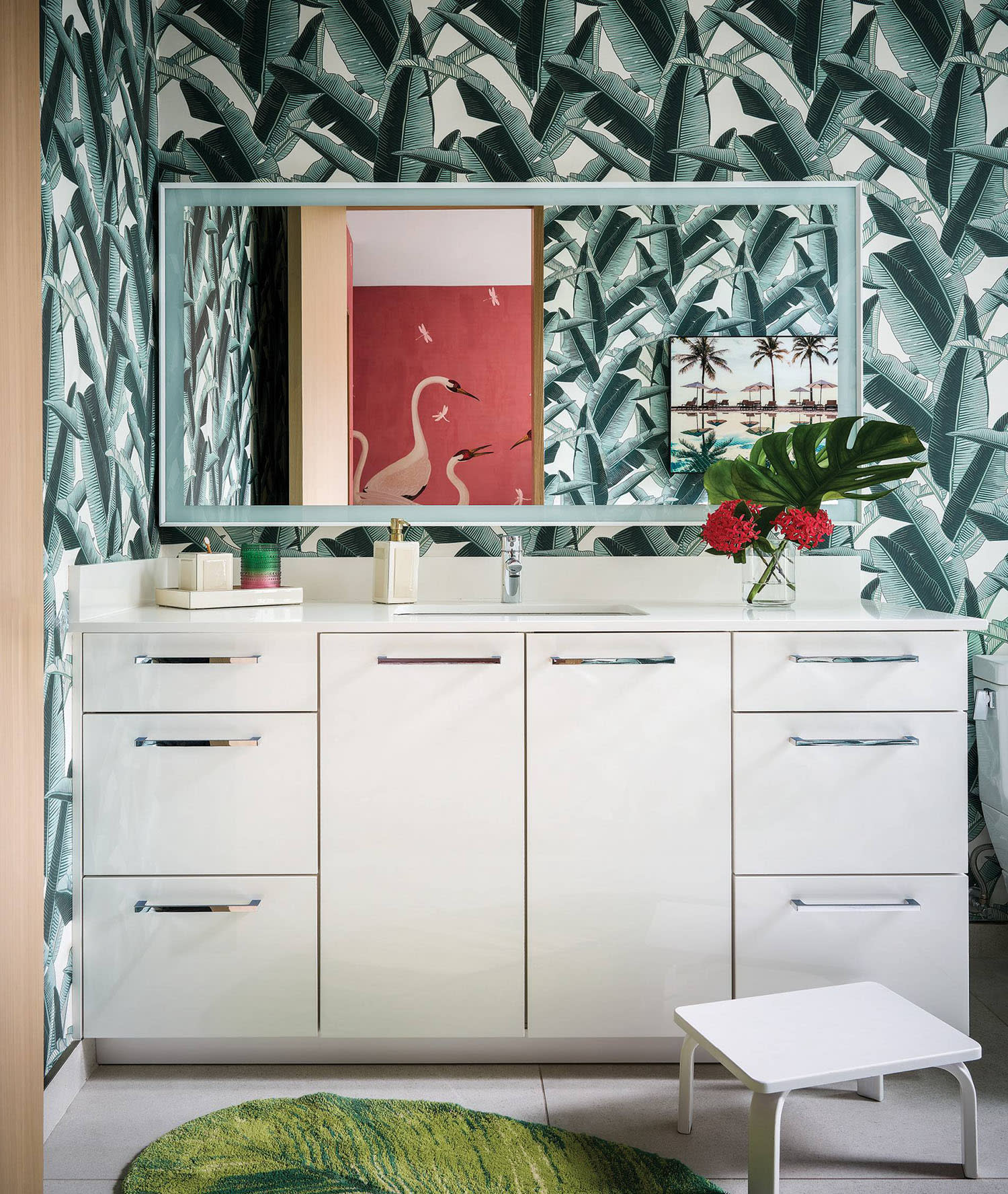 bathroom with a tropical wallpaper and white vanity