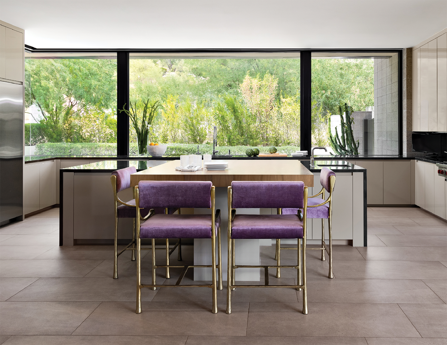 contemporary kitchen with purple-hued chairs surrounding an island