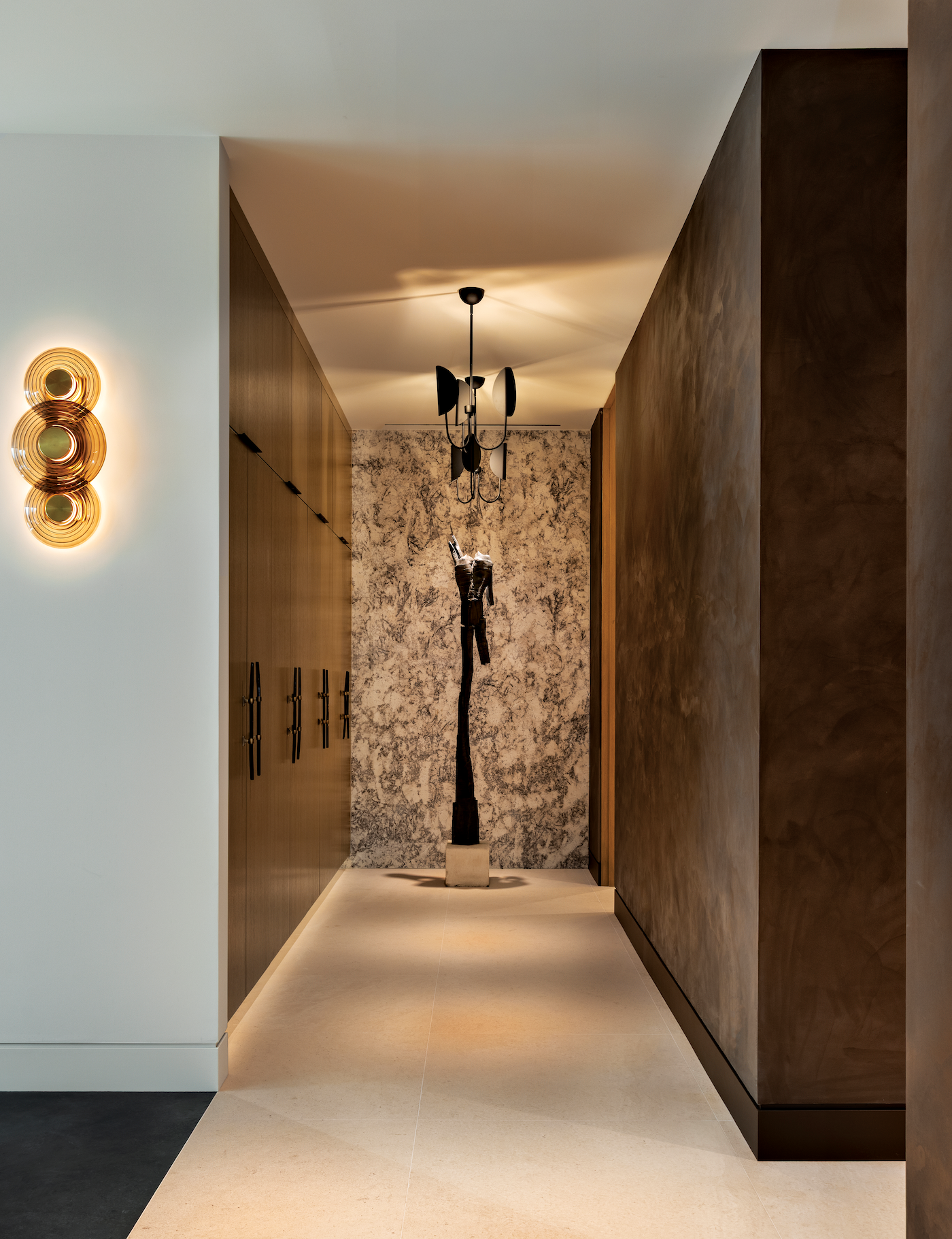 An untitled bronze sculpture by Louis Longi serves as focal point in this transition space.