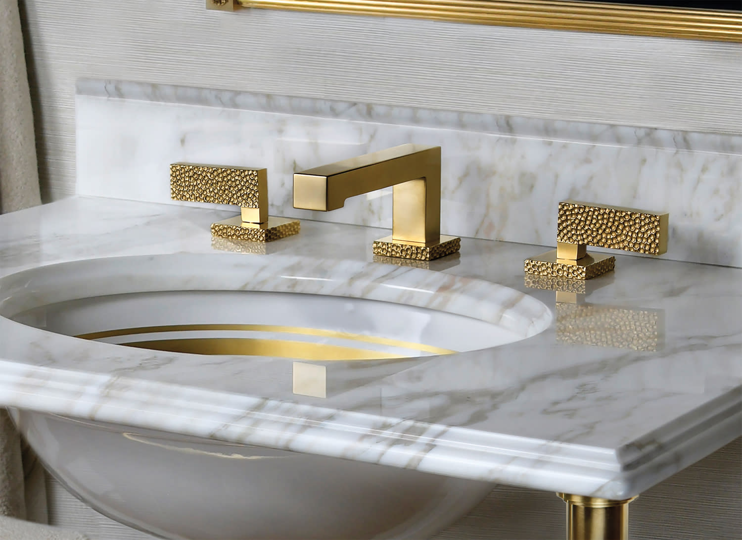 brass bathroom fixture with a hammered finish