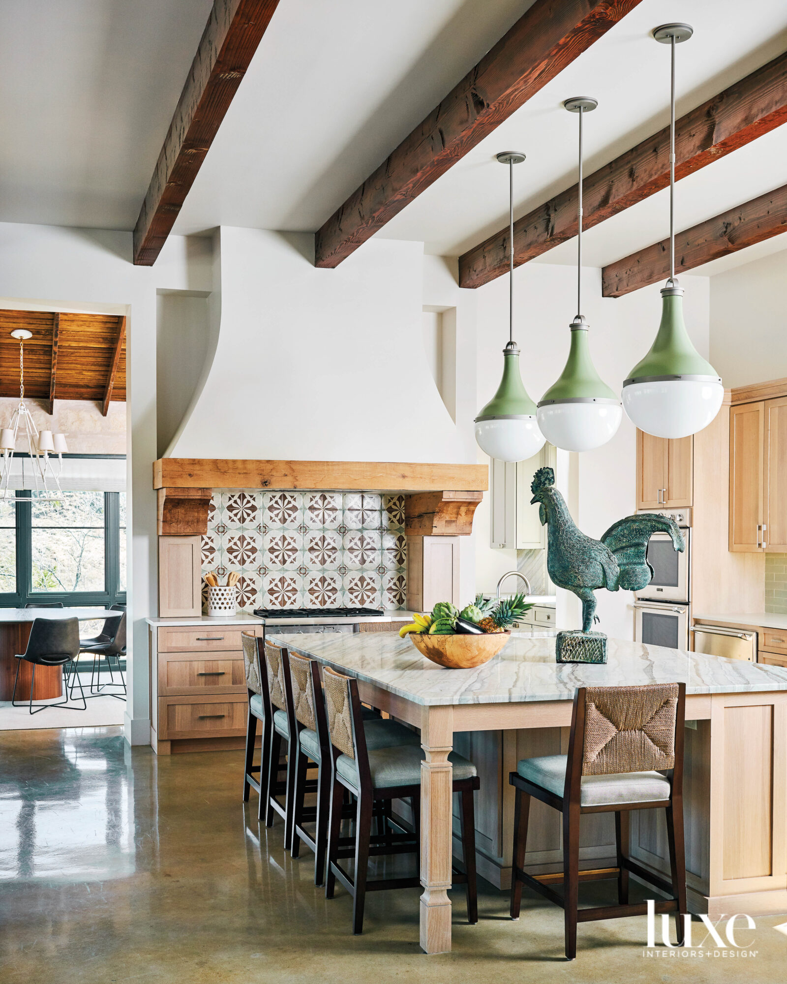 Kitchen with statement backsplash and vent hood.