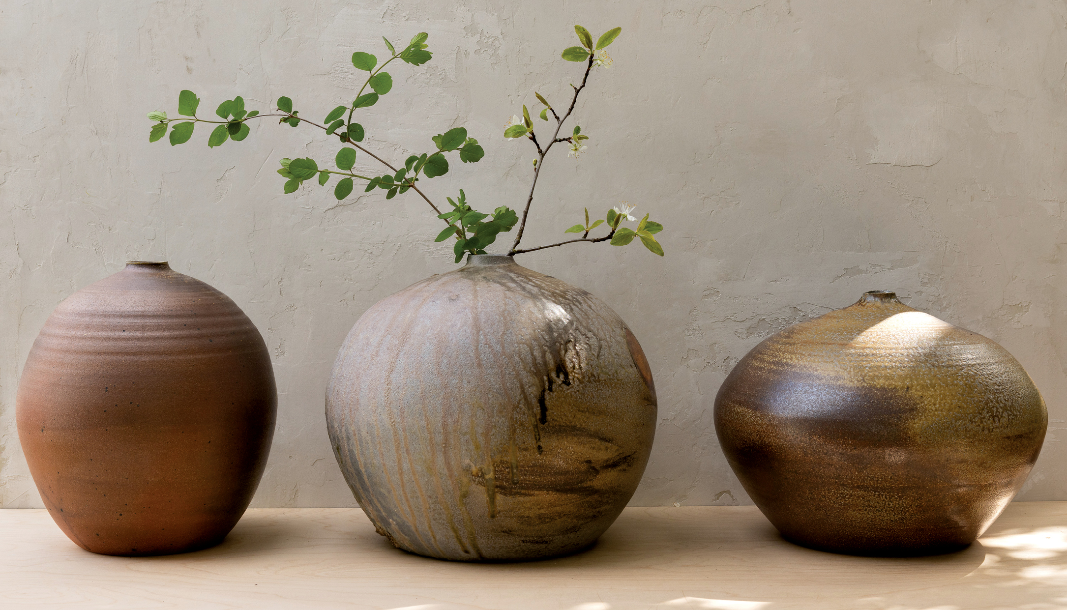 a trio of ceramic vases