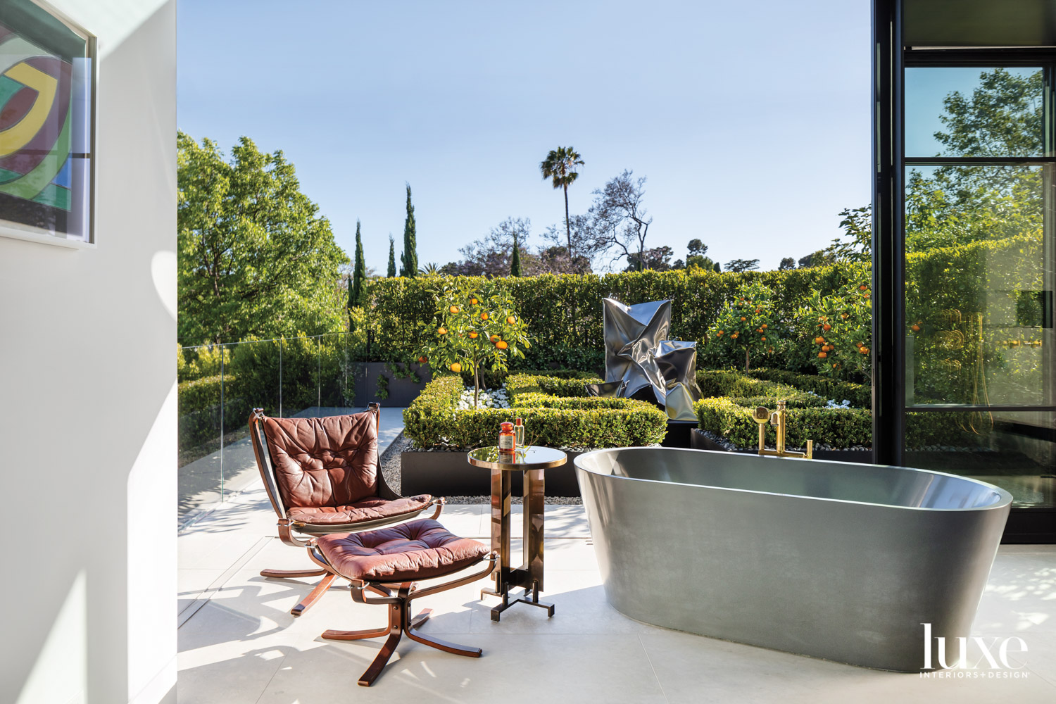 Modern bathroom with freestanding tub and outdoor view serve as luxury garden design inspiration