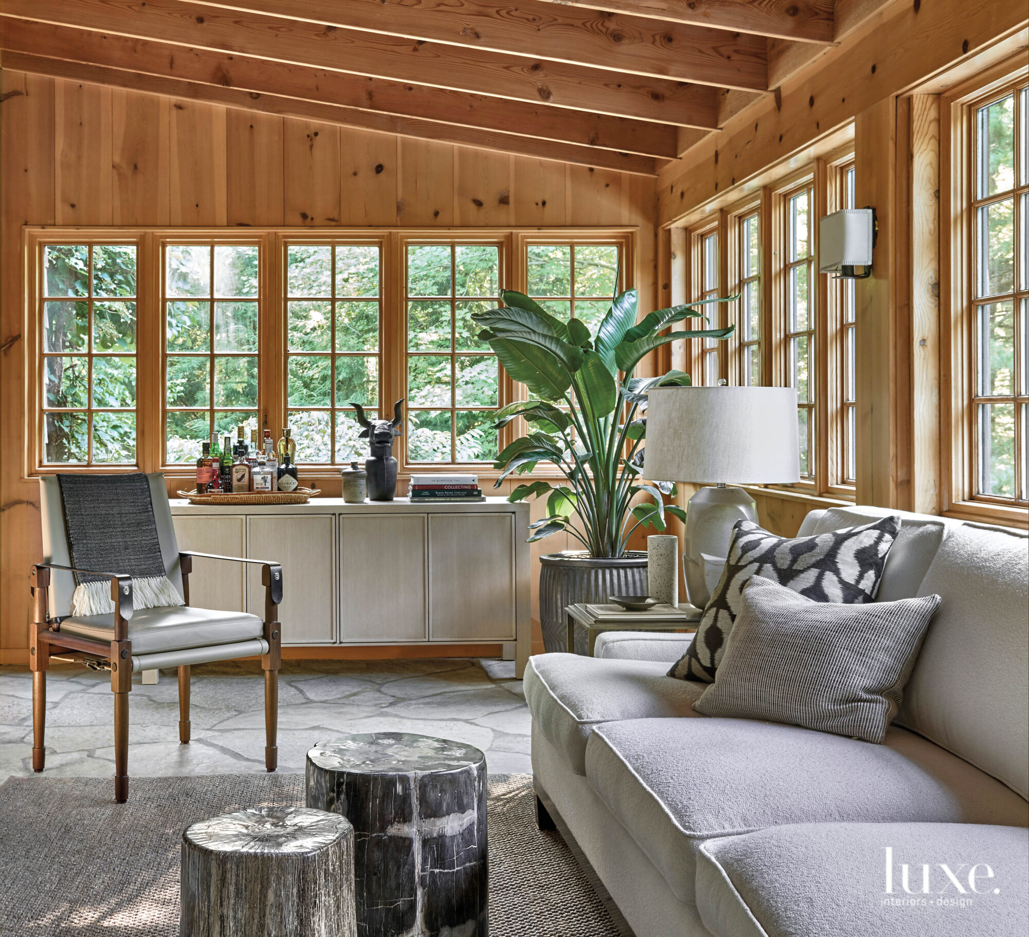 Bright light floods the appropriately named sun room, spotted with neutral-toned furniture.