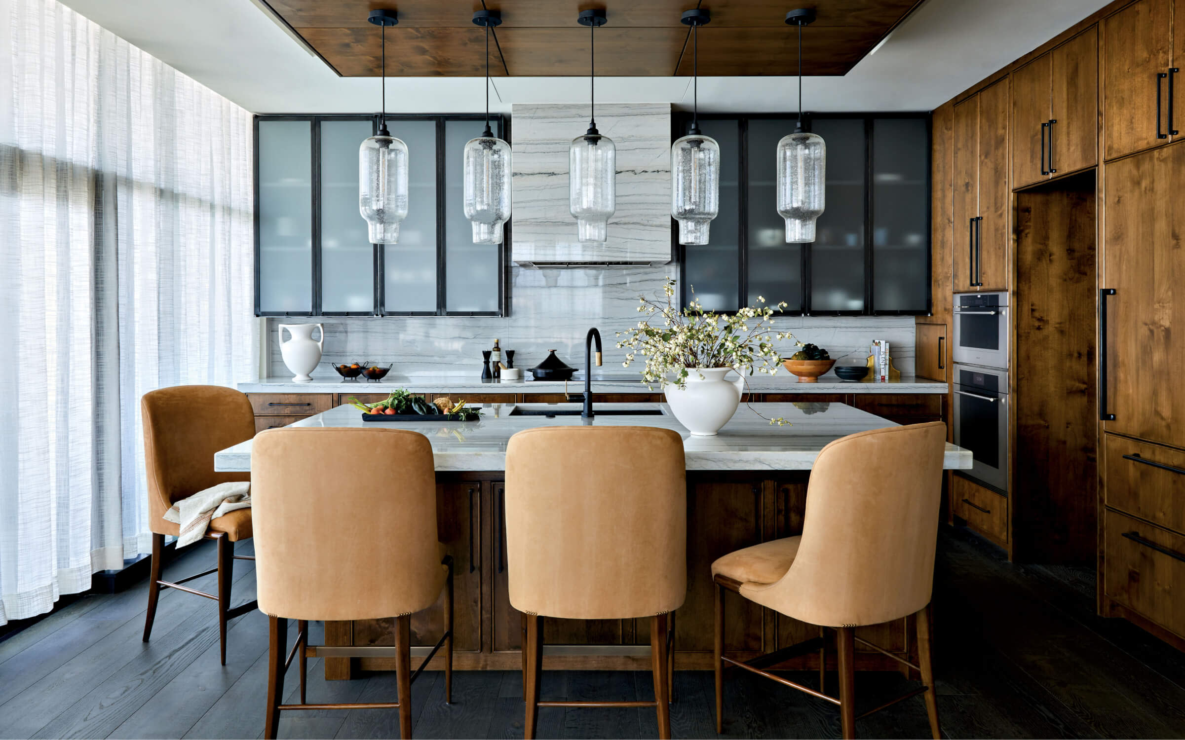 contemporary kitchen with an island topped by a string of pendant lights