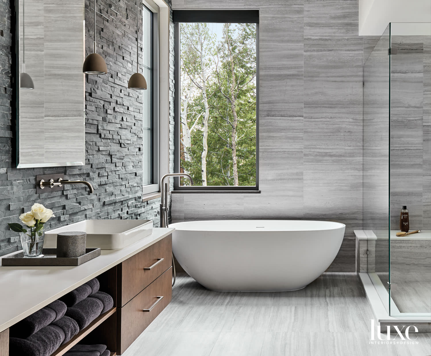 main bathroom with concrete pendant and white soaking tub