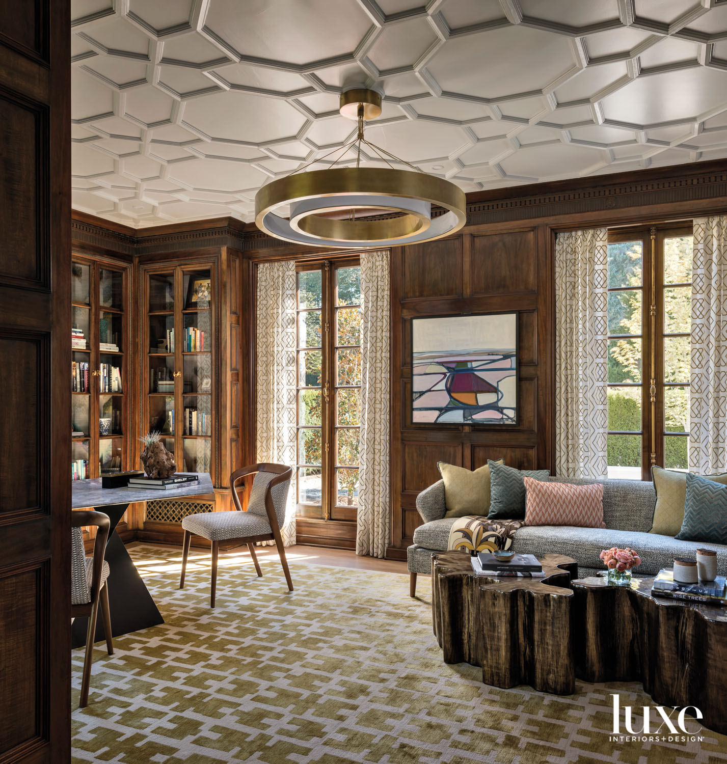 Library featuring game table and chairs, round light fixture, french doors, sofa and coffee tables