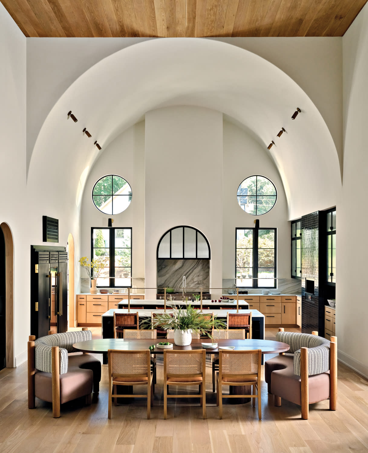 modern dining room with an arched ceiling