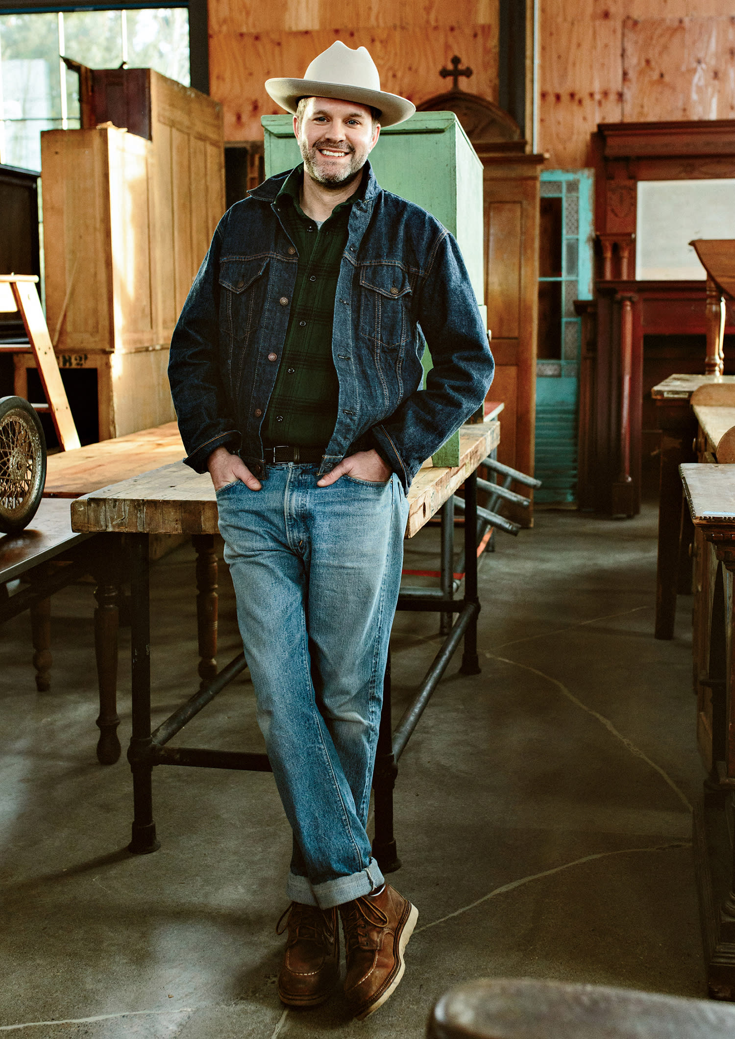 designer Max Humphrey standing in a rustic workshop