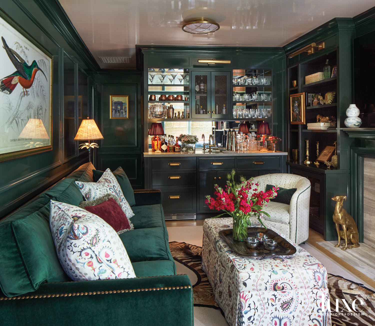 Dark green library with velvet sofa