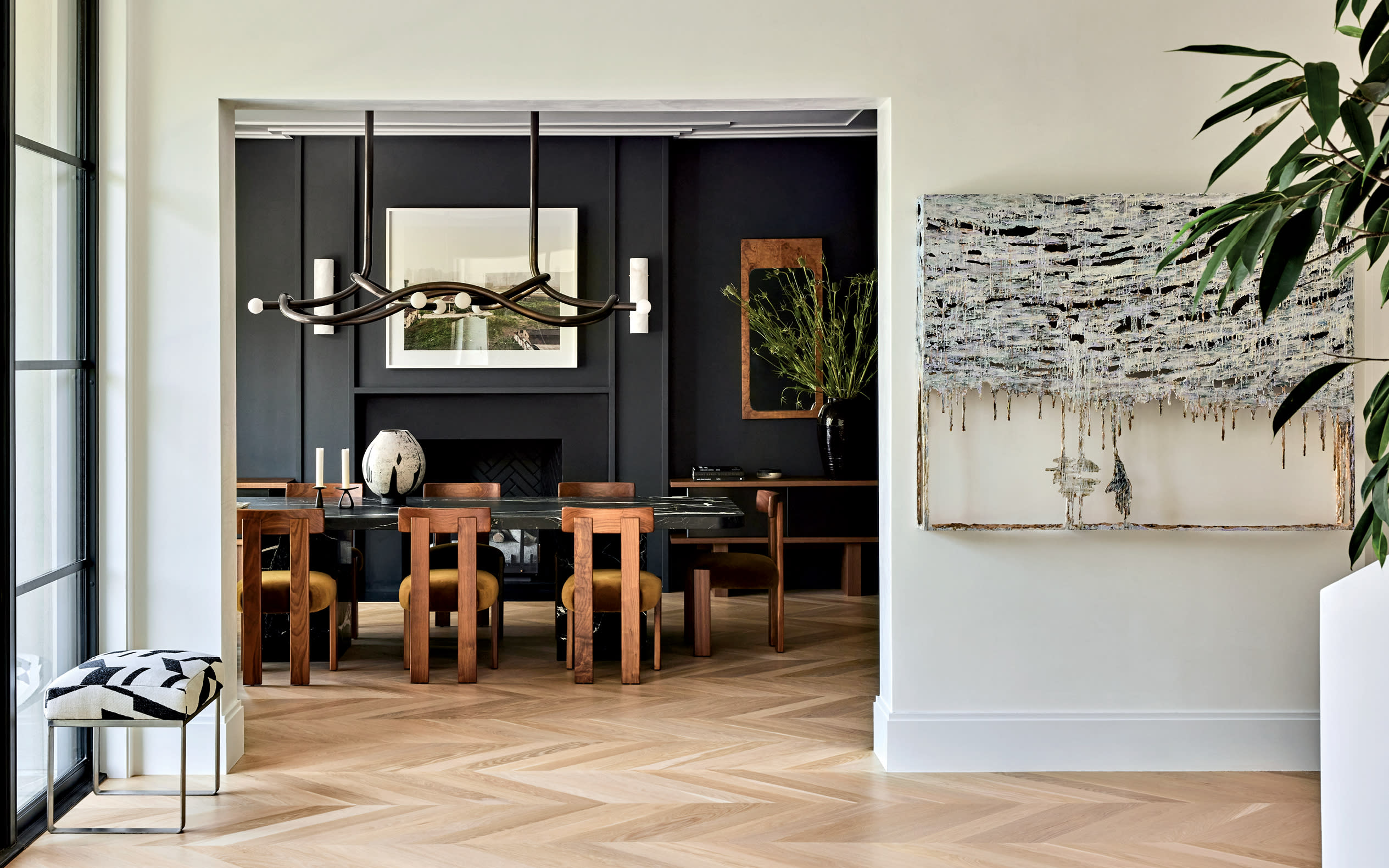 oak floors in a chevron pattern in the entryway of a modern home