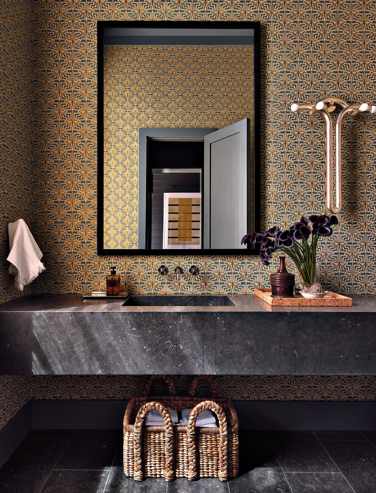 Art Deco-inspired powder room with a black marble sink