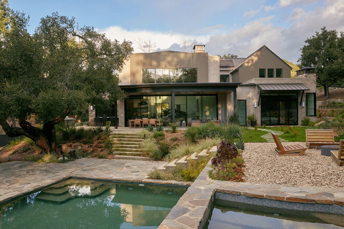  A contemporary home featuring a swimming pool and a spacious patio area for outdoor relaxation.