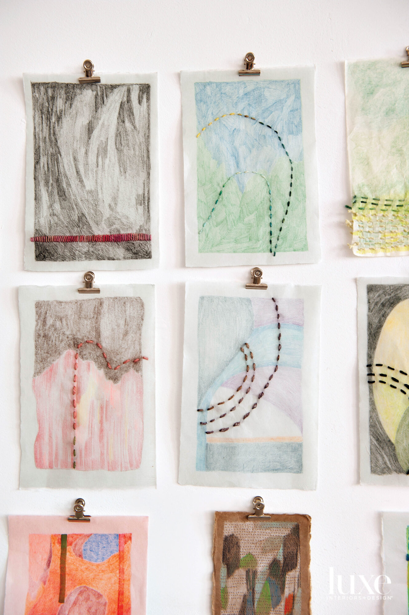 Nine small drawings with yarn stitched into the paper.