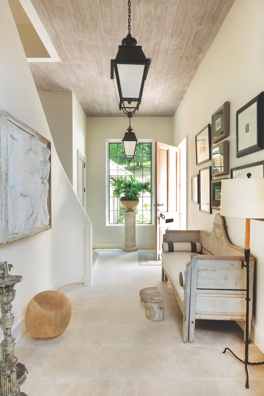 Dubuisson Limestone in home entry way foyer with pendant lighting and artwork