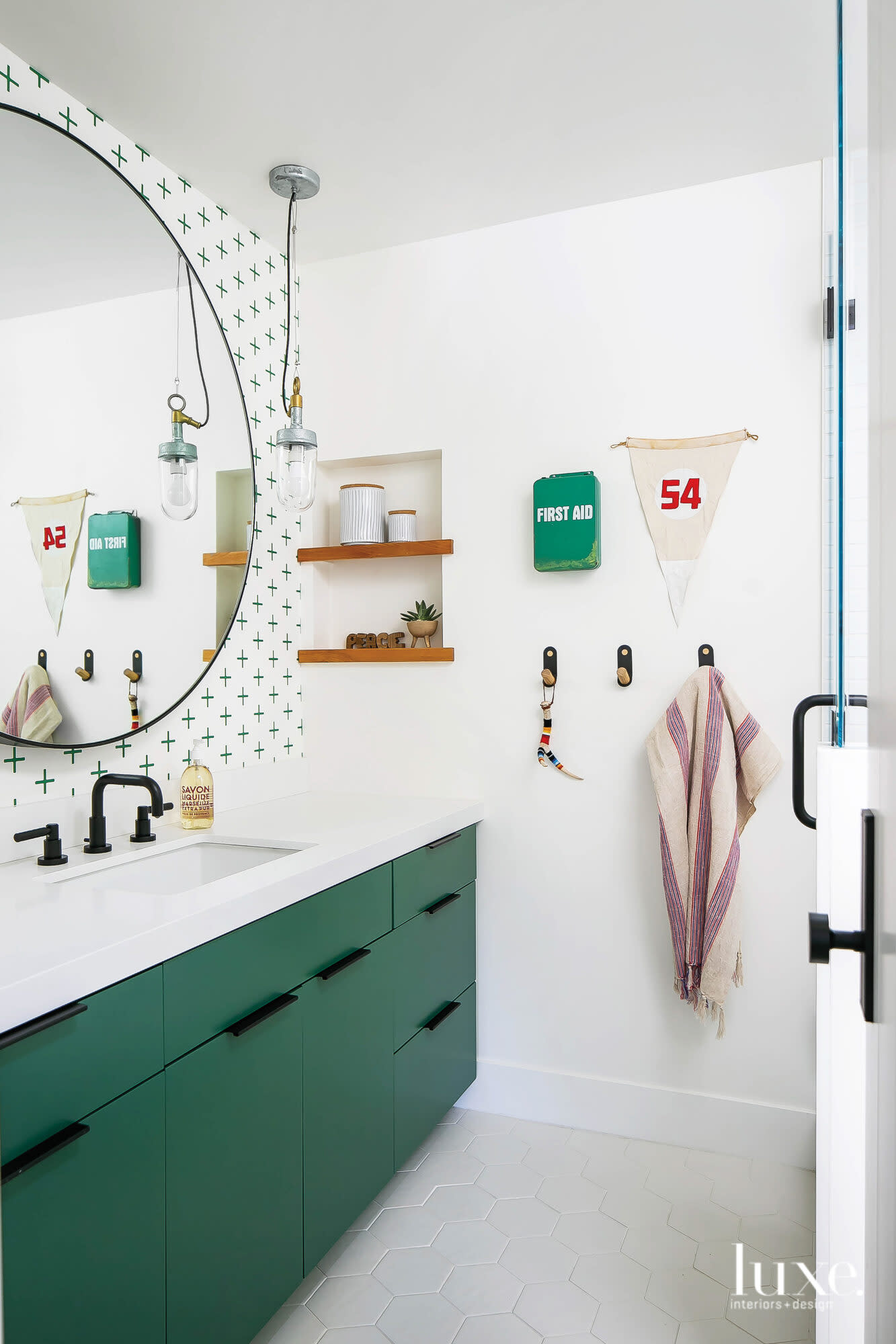 Bathroom with green vanity and vintage accents