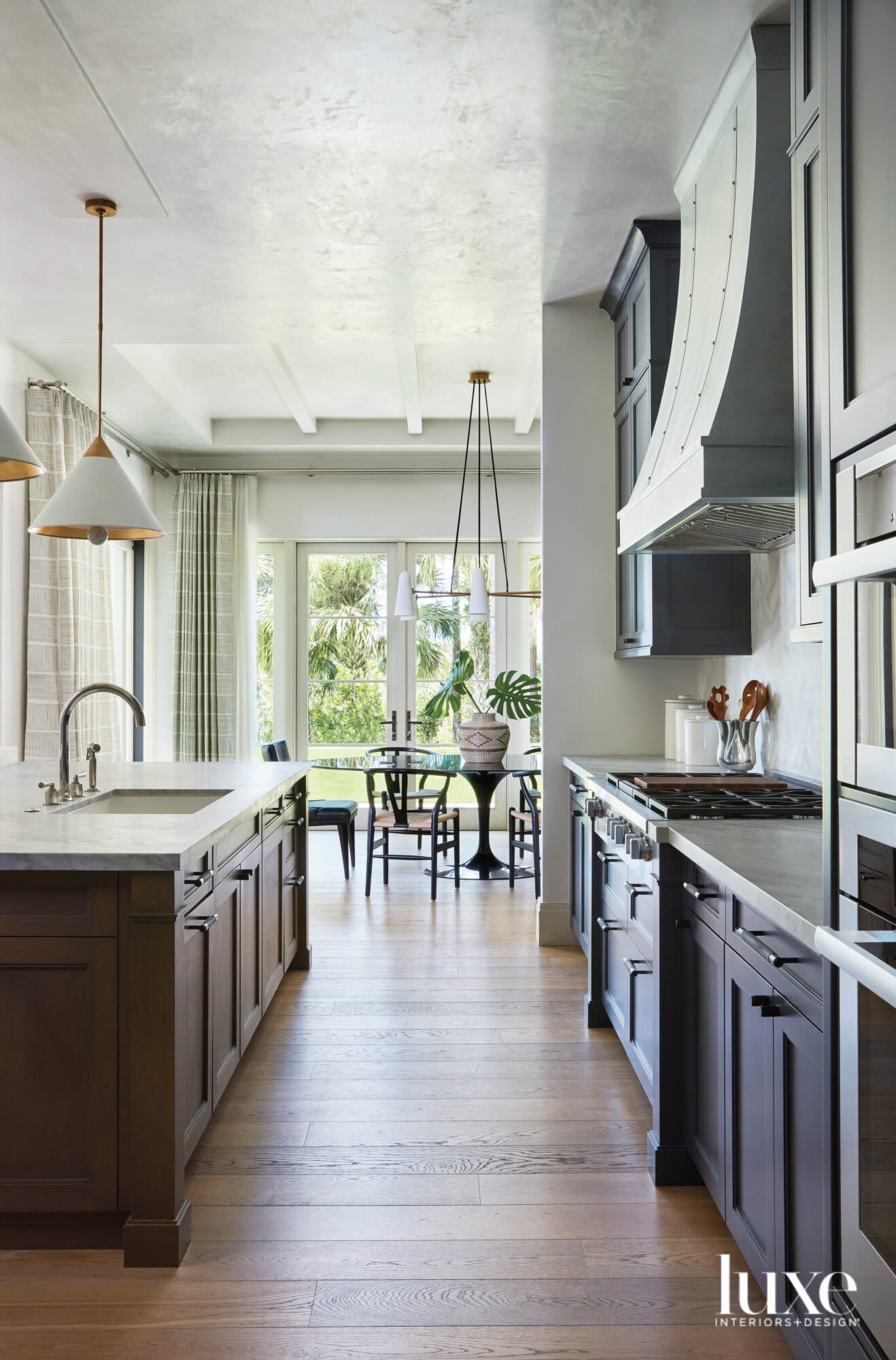 kitchen with gray cabinetry, wood flooring and island