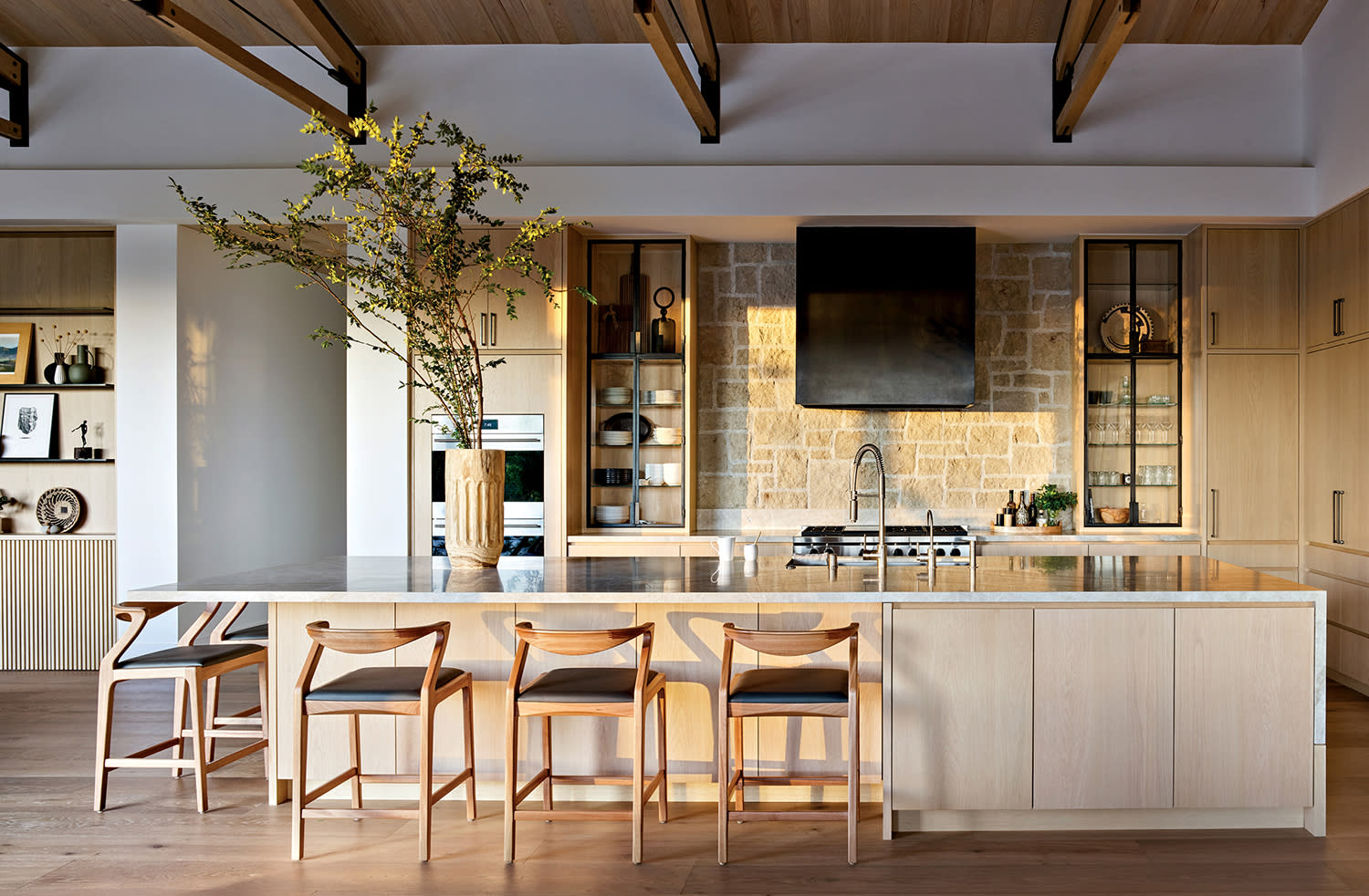kitchen with stone backsplash and a large island