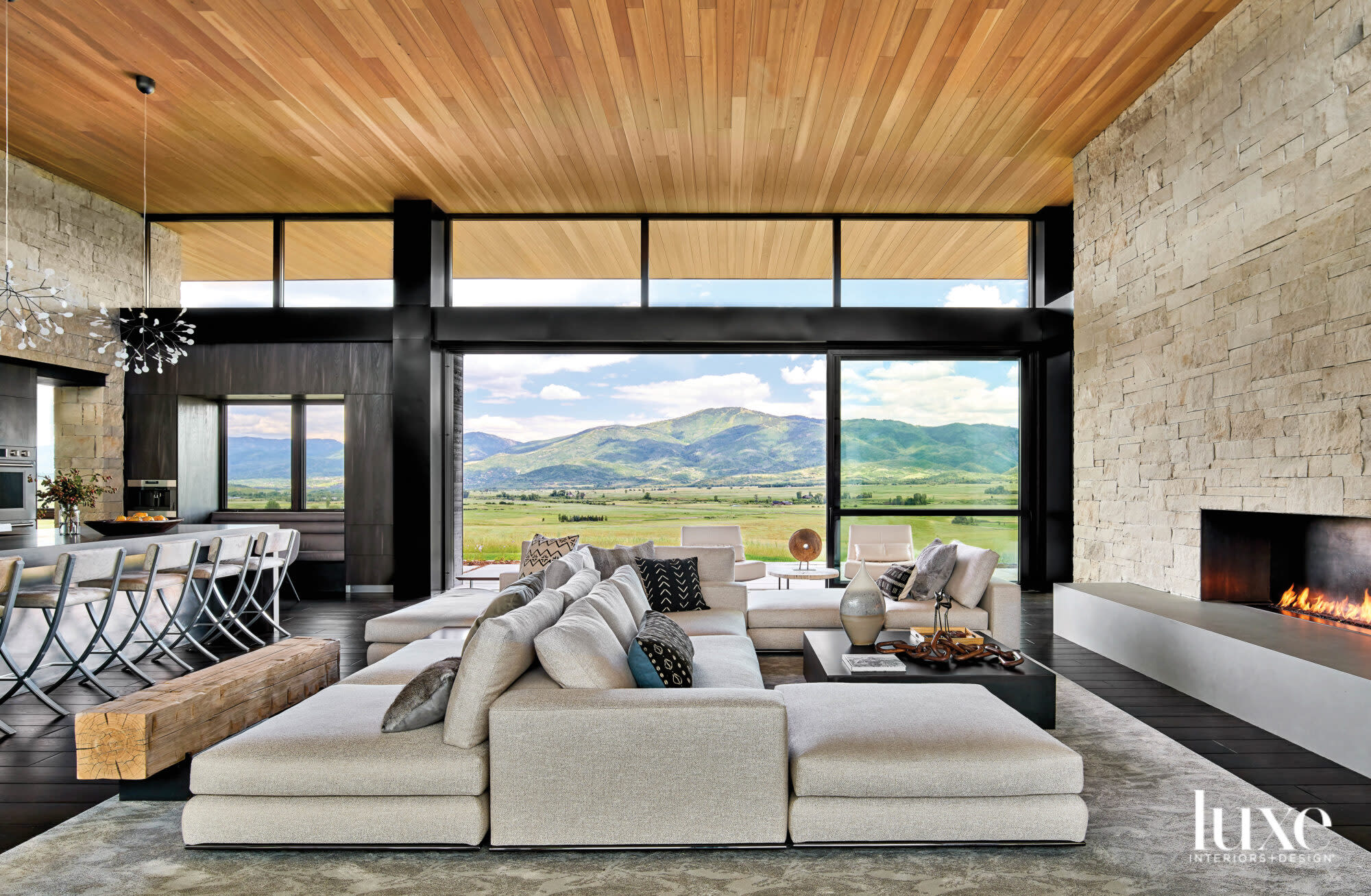 Tan modular sofa faces the great room fireplace.