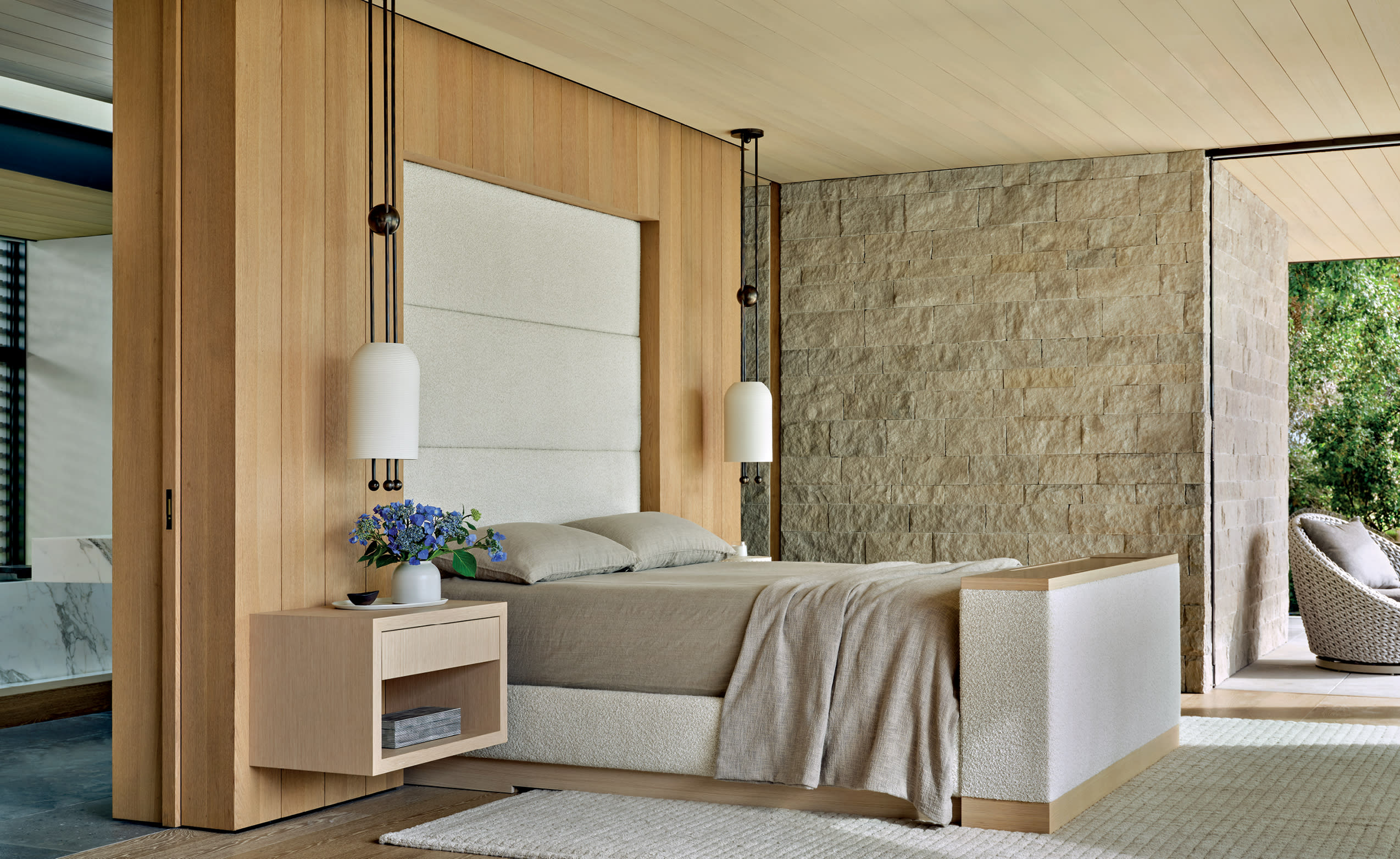 neutral organic primary bedroom with tufted headboard and tan bedding