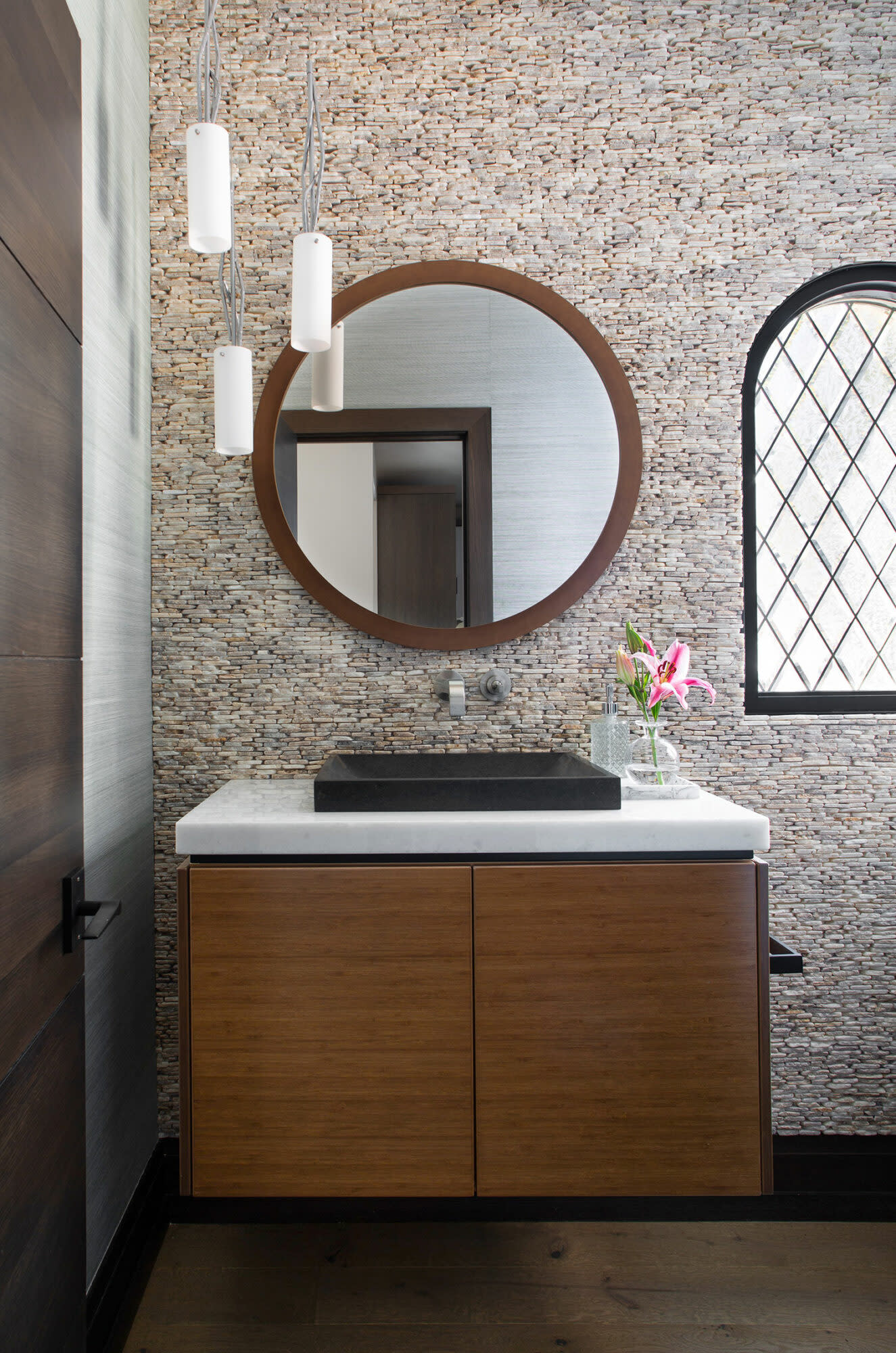 powder bath with river rock backsplash and wood vanity