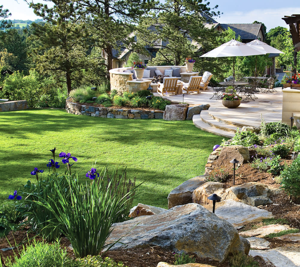 An inviting patio set amidst a beautifully manicured lawn, offering a peaceful outdoor retreat.