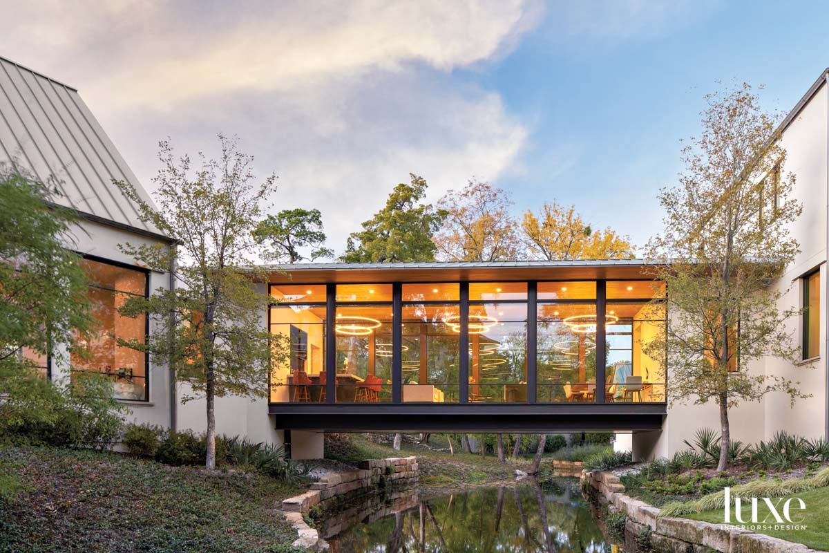 glass house exterior with creek