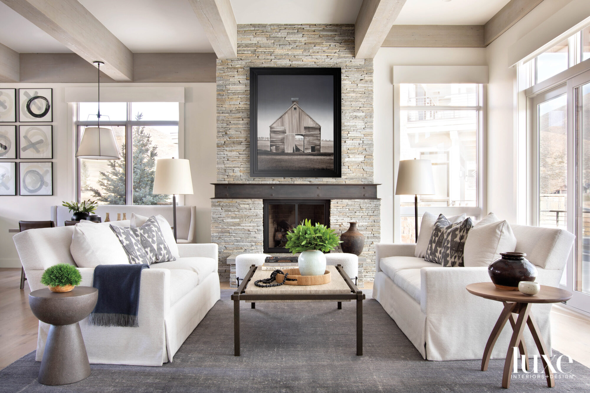 Living room with two couches and a coffee table with fireplace in background