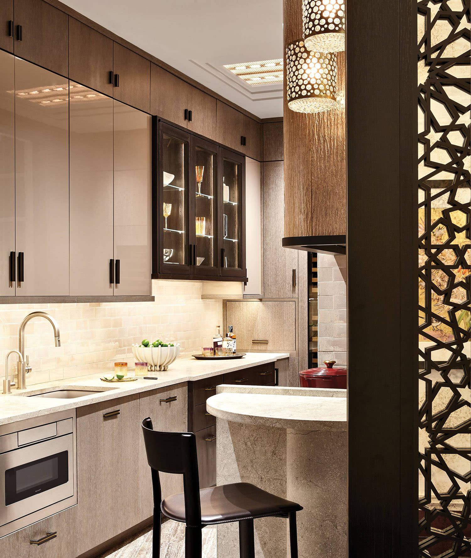 kitchen with cerused oak, lacquer and plaster cabinetry and limestone countertops
