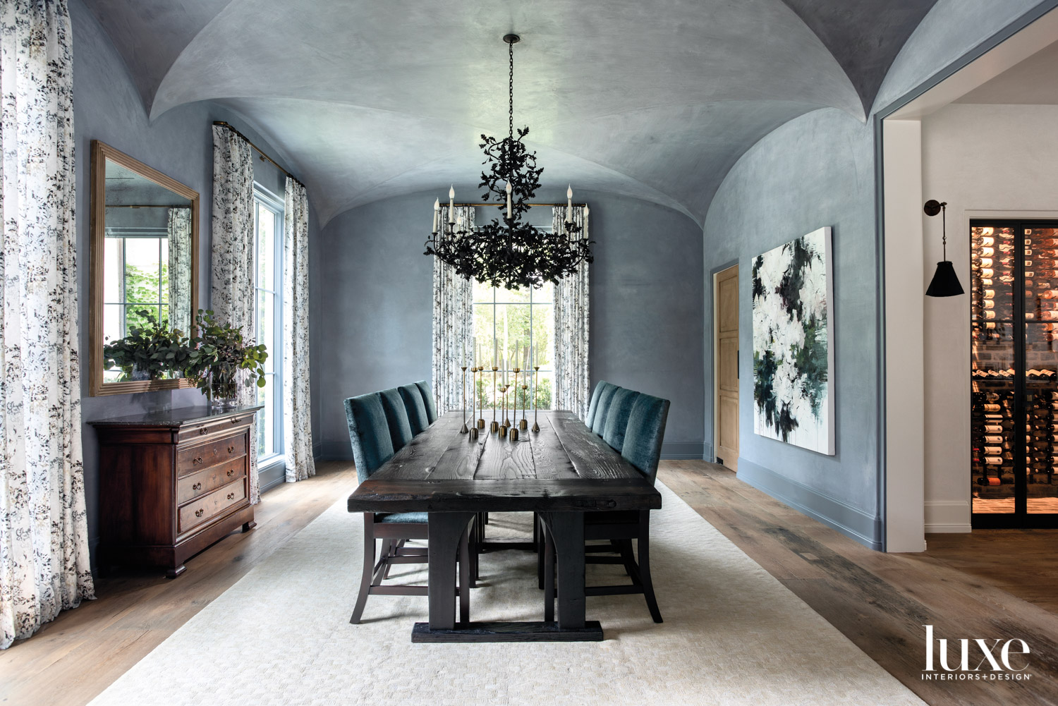 Dining room with plaster walls and branch-like chandelier