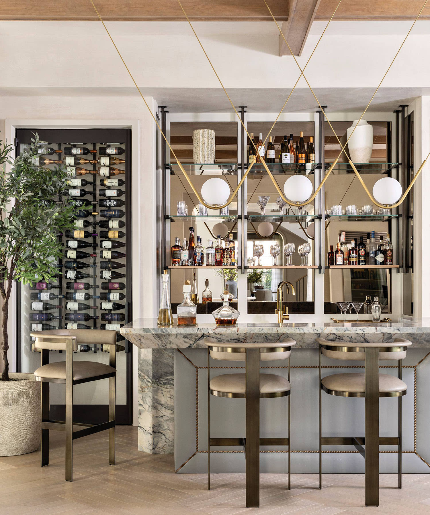 mirror-backed bar with a Larose Guyon light fixture and marble counters