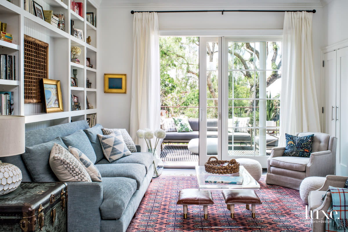 transitional living room pale blue sofa pink rug