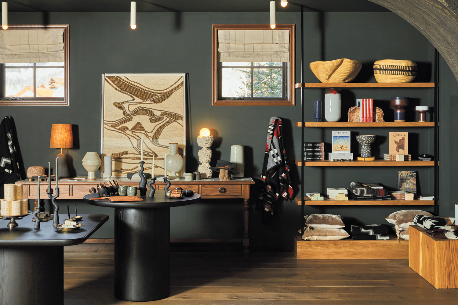 Hotel retail space with local goods including candlesticks, pillows and lamps on wood shelving