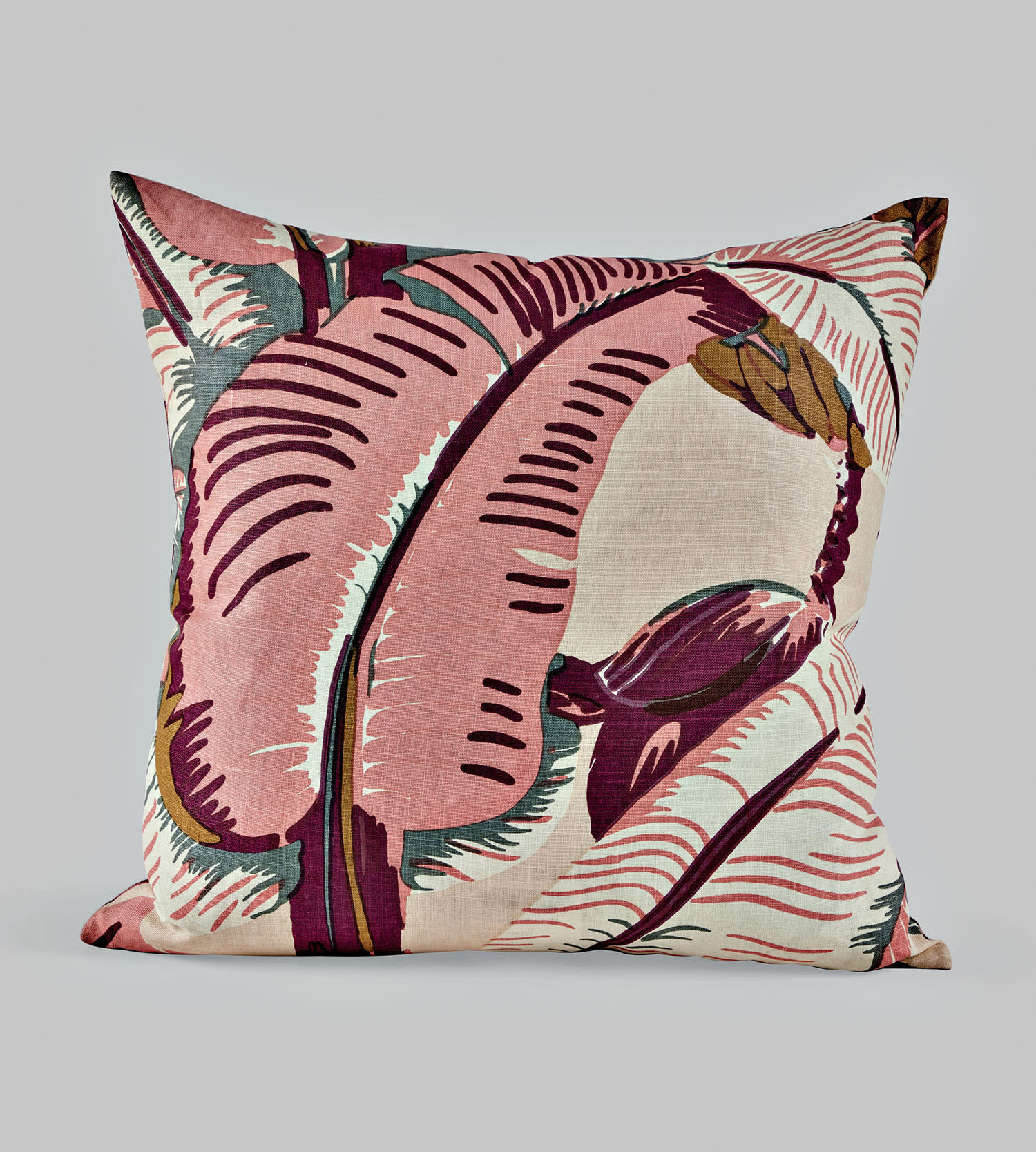 A colorful throw pillow in shades of pink, green and white.