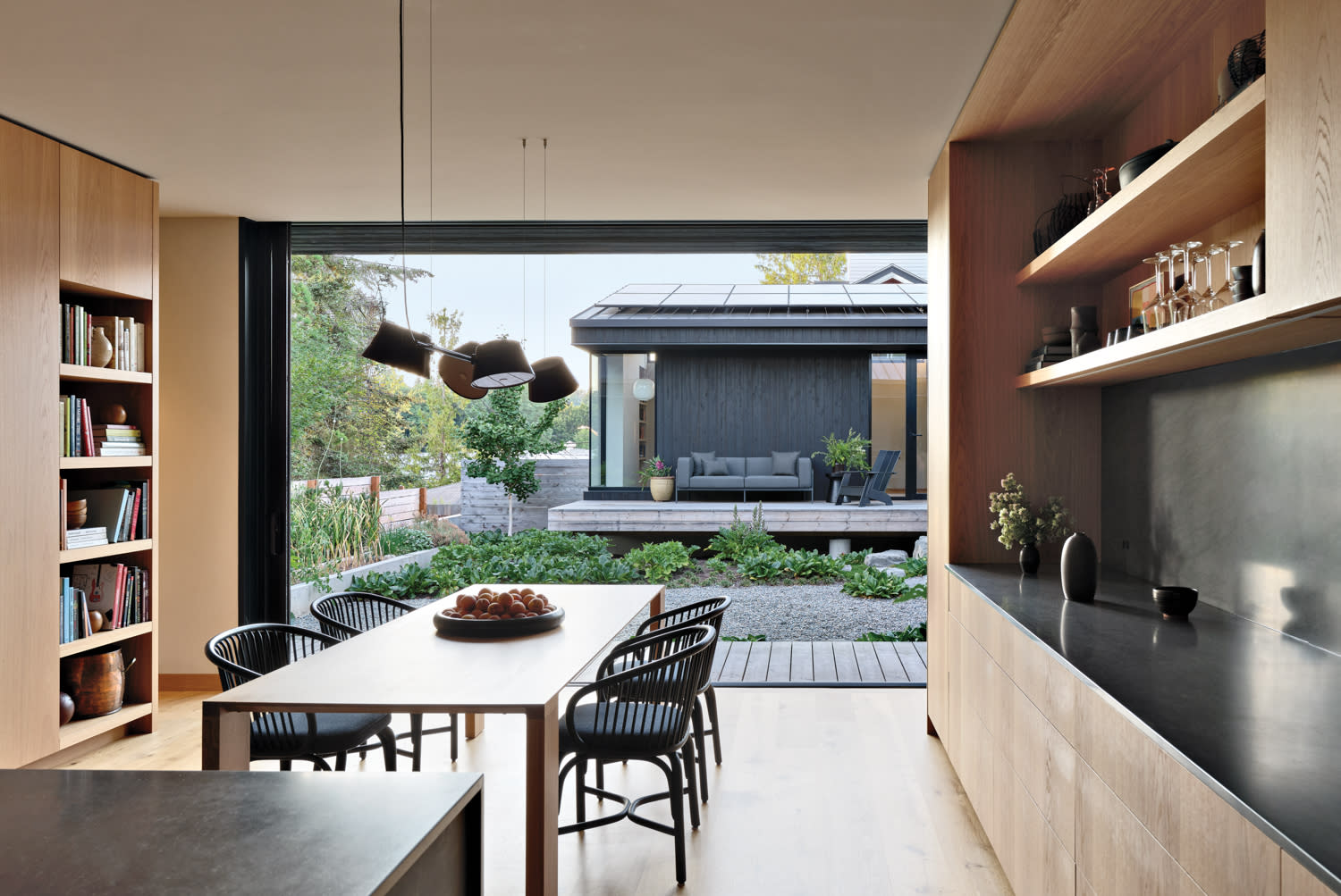 minimalist dining room clad in light oak