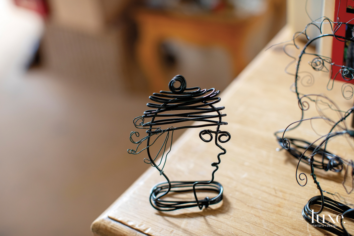 A wire sculpture head by the artist is one of a series.