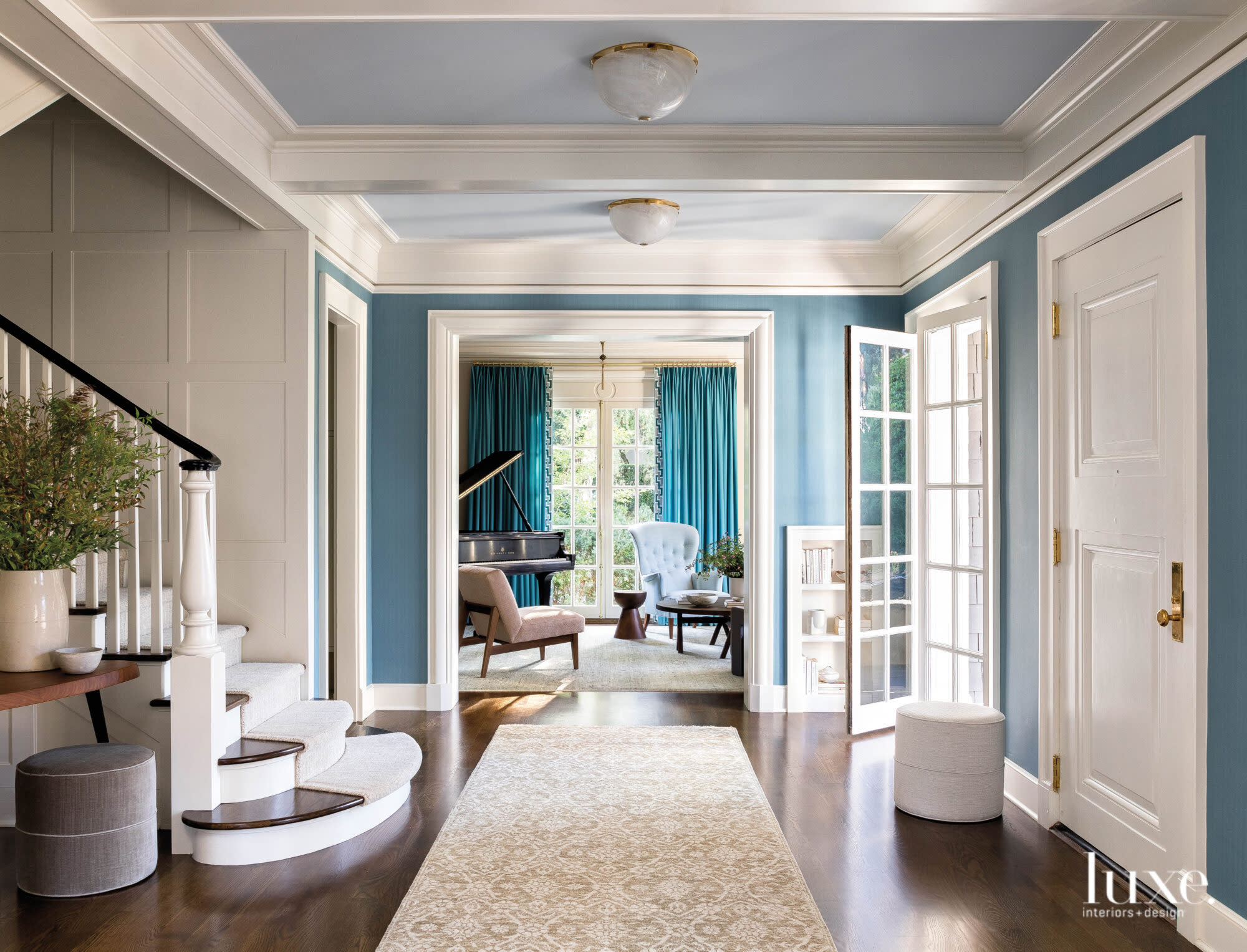 A bright, blue-painted entry looking into living room