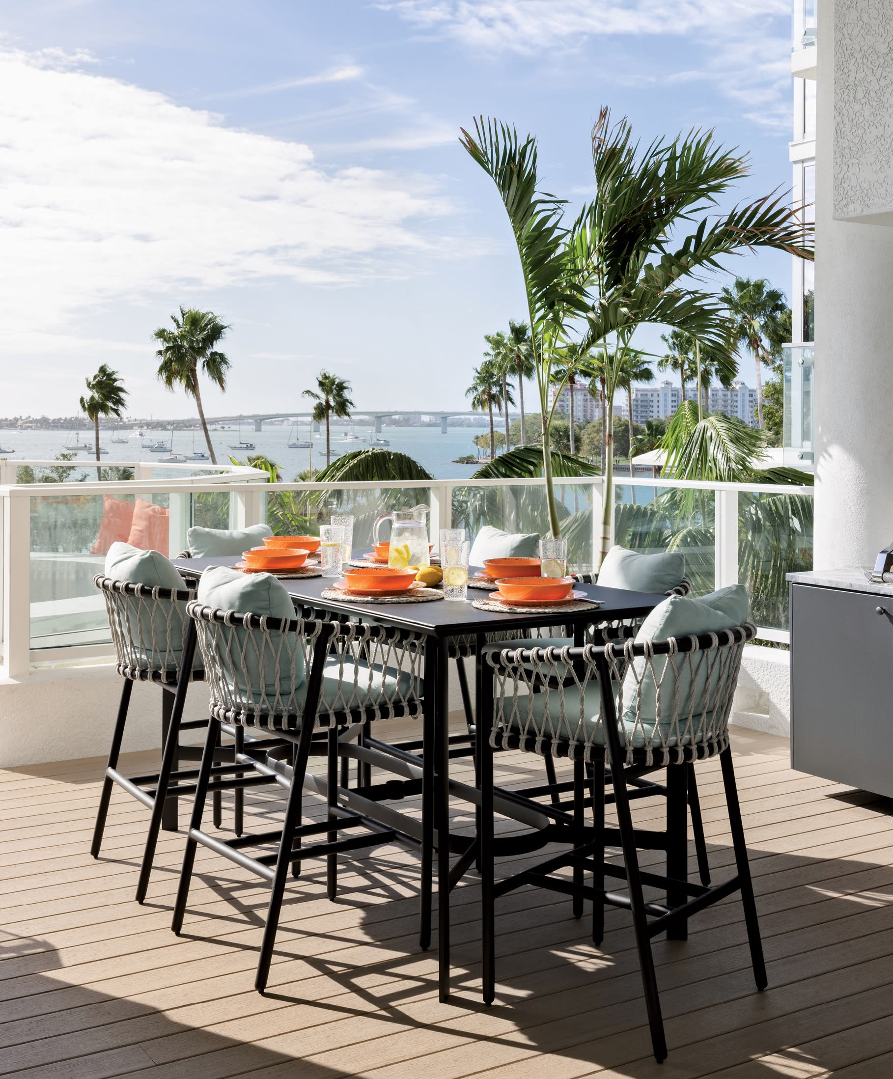 al fresco dining area on a Sarasota home with views of the bay beyond