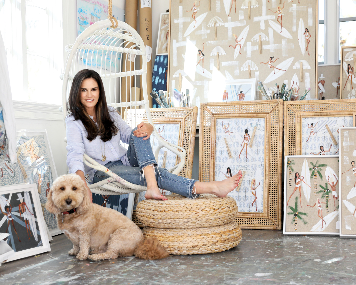 Kathleen Palmeri with her dog among her artwork