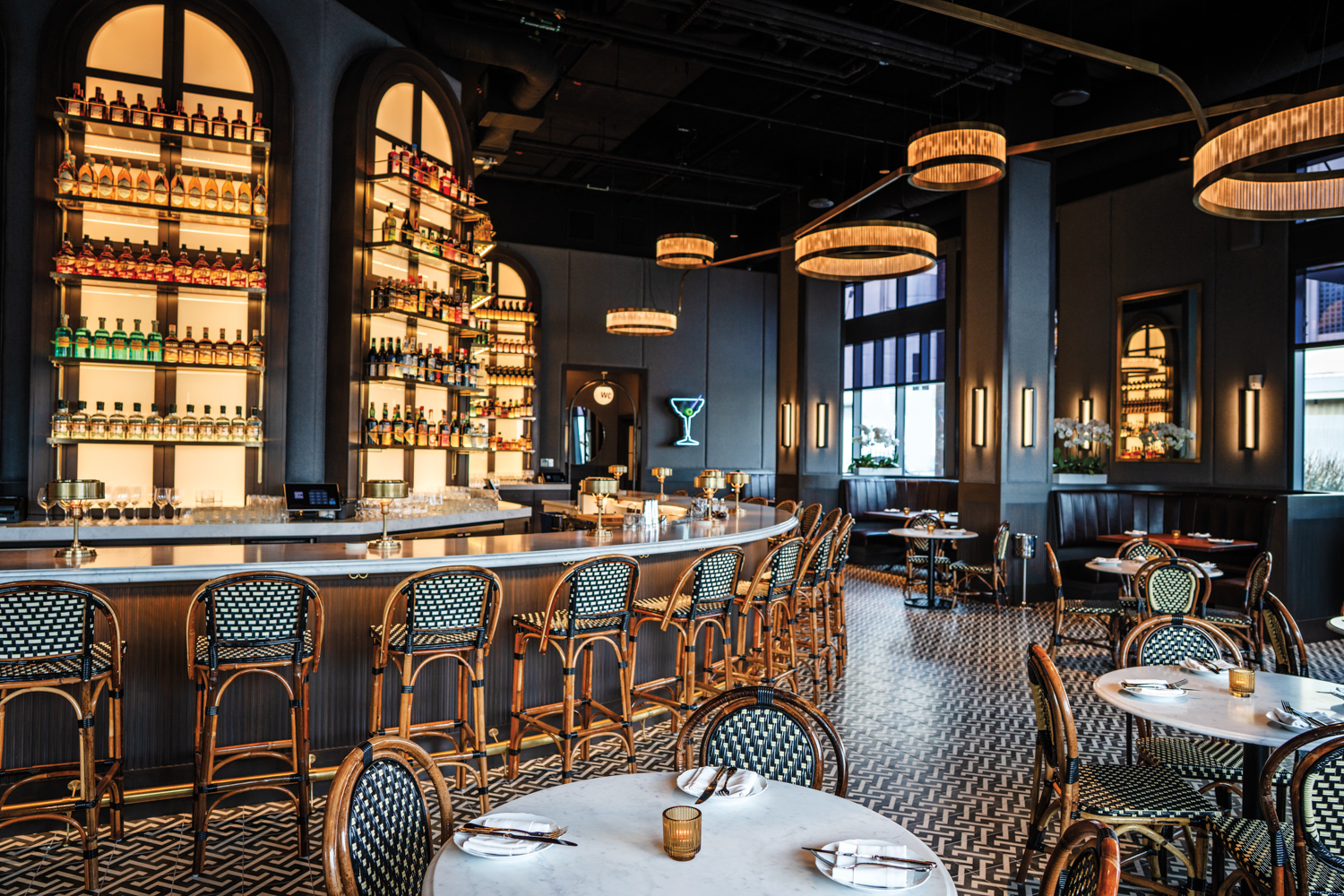 Restaurant with black-and-white flooring, black-and-white wicker chairs and dark blue walls