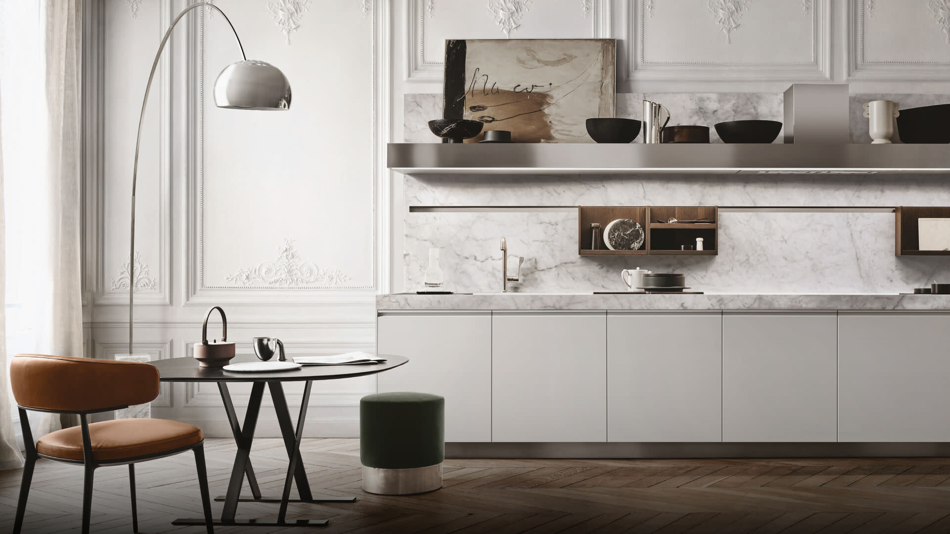 Image of a contemporary kitchen with marble counter tops, a table, and a wet bar.