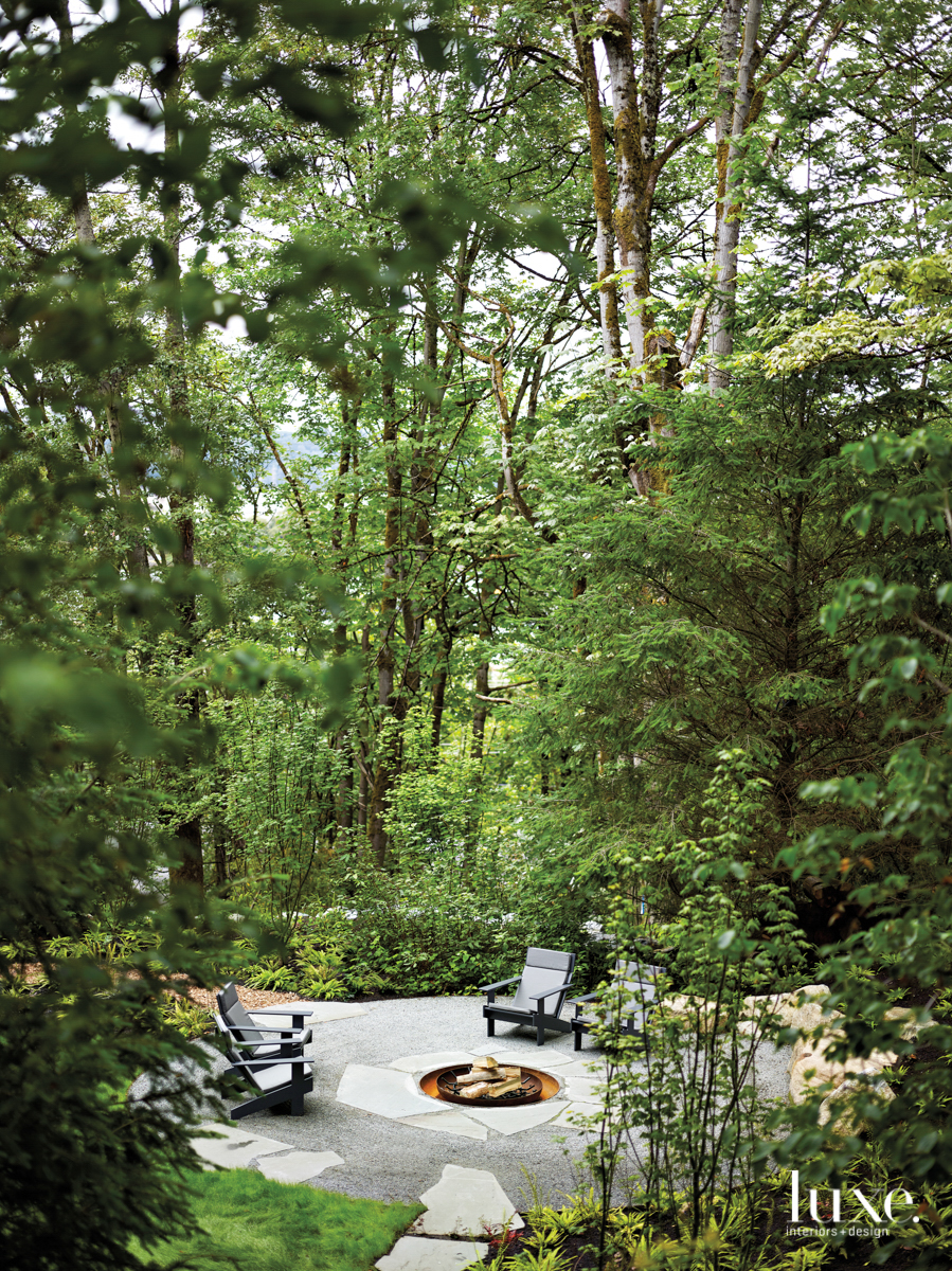 outdoor fireplace with grey chairs around the fireplace