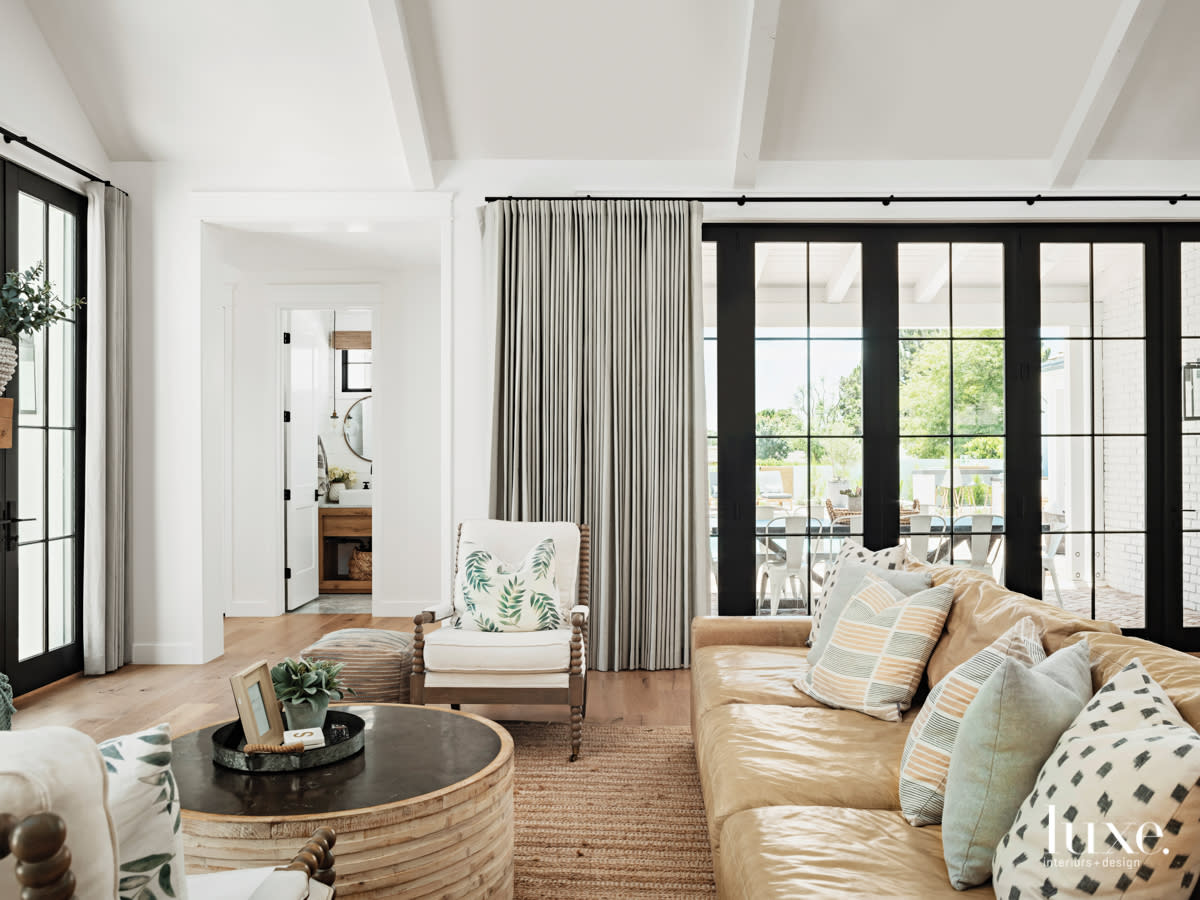 lounge area with leather couch and floor to ceiling windows