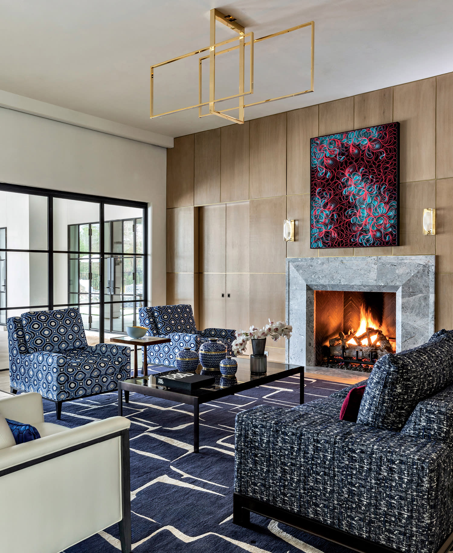 modern lounge with oak walls, blue seating and a blue and white carpet