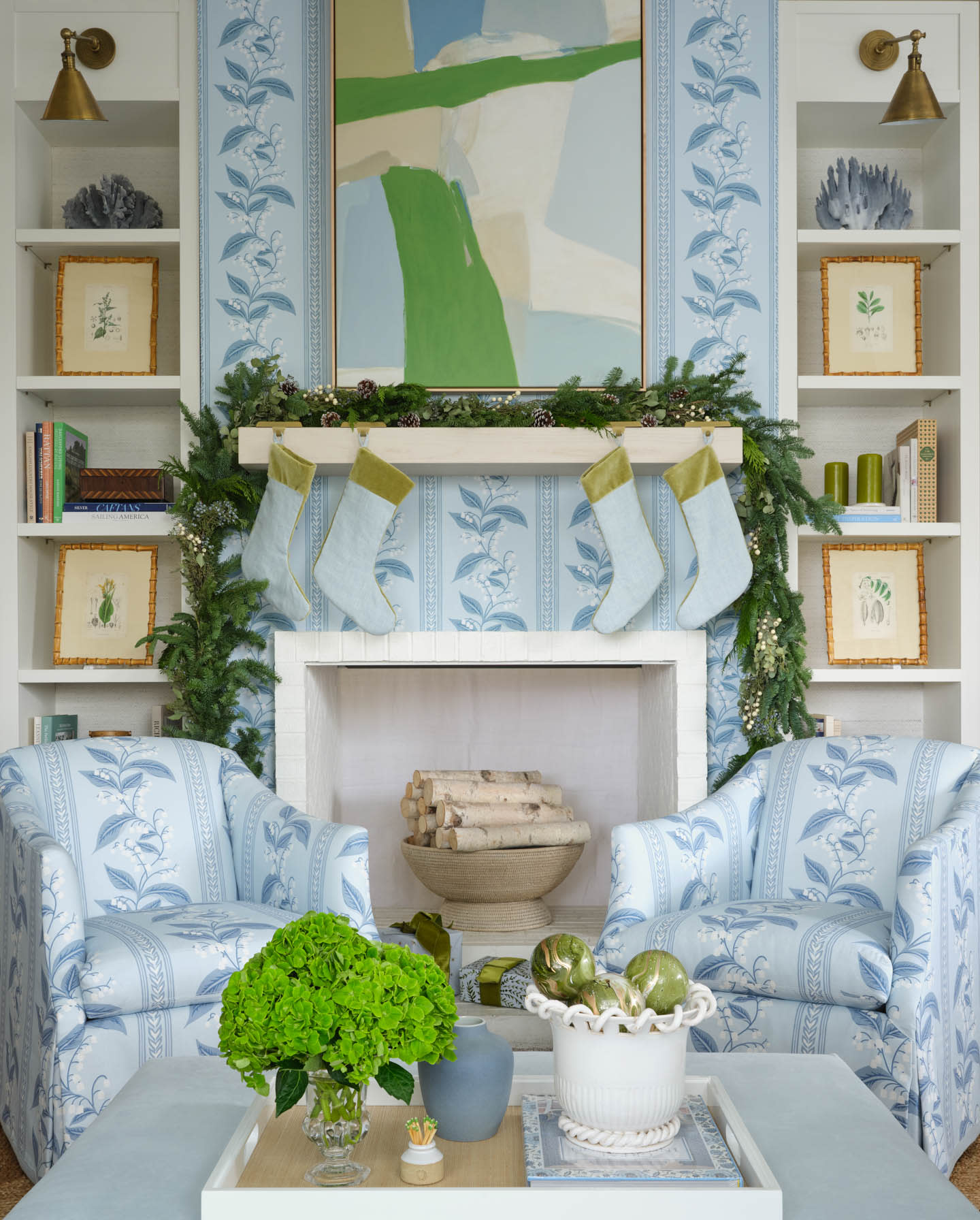 Christmas fireplace vignette with a blue floral backdrop and a matching pattern on the armchairs