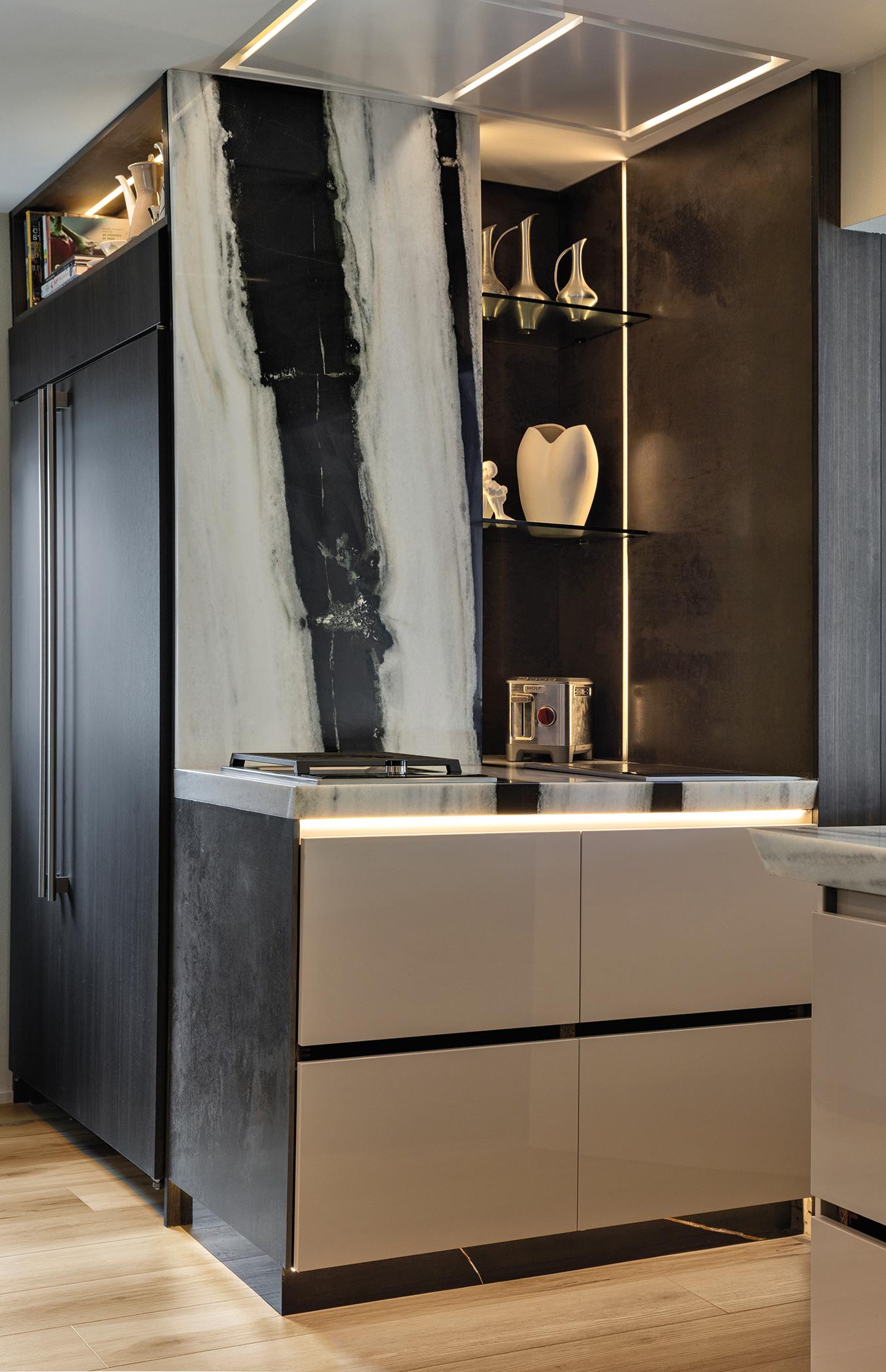 Custom cabinetry by Chic Design Group in the Pazzam Project, featuring creamy lacquered flat panels, exotic wood accents, and furniture-like detailing.