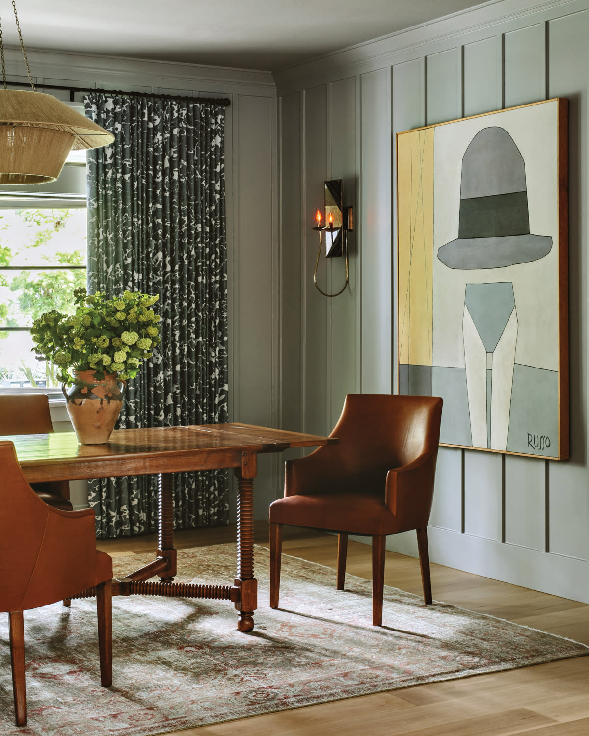 traditional dining room with artwork depicting a top hat silhouette