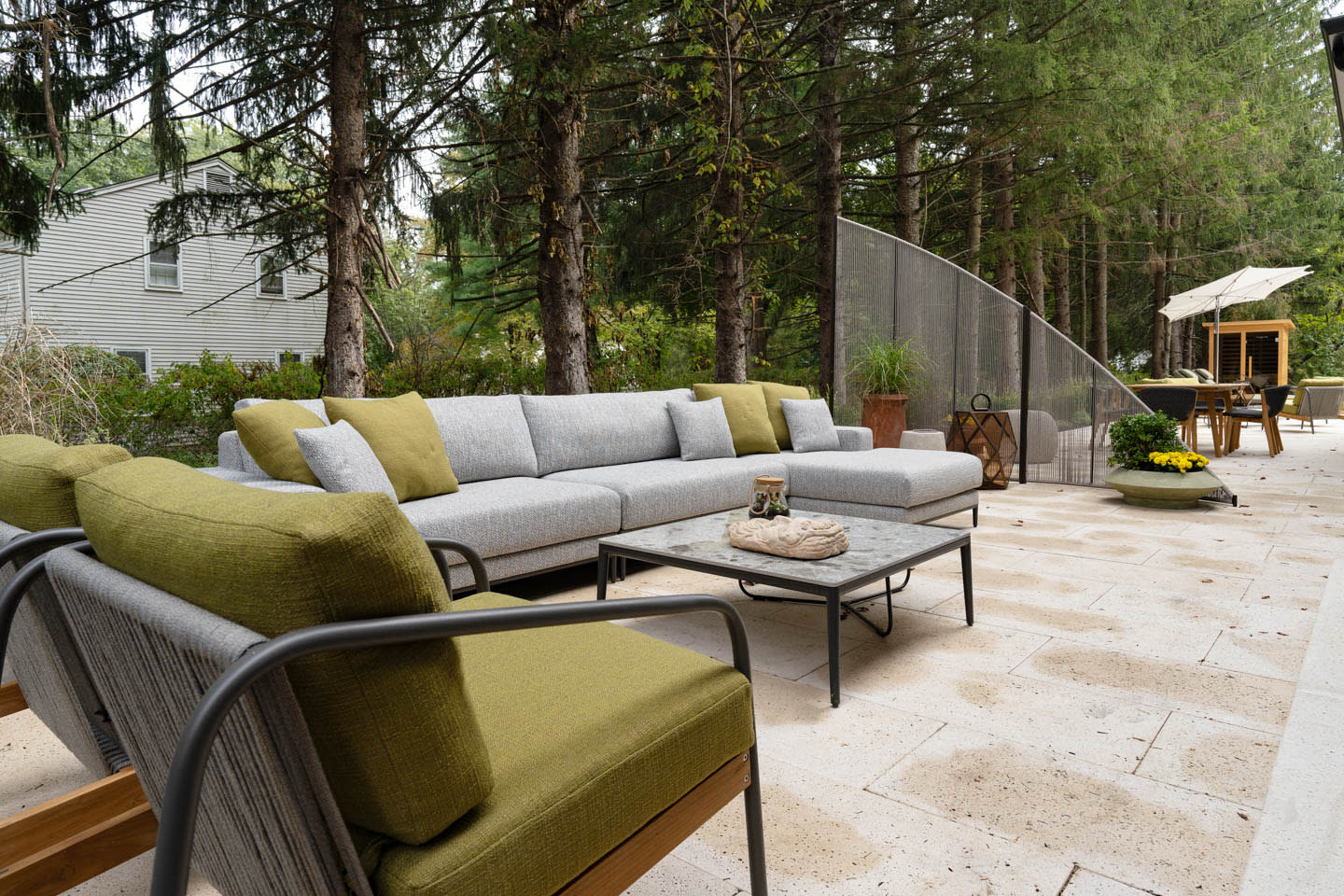 pool deck with green and gray seating and a stone deck floor